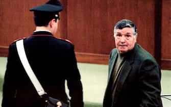 A picture taken on March 8, 1993 shows mafia boss Salvatore "Toto" Riina during his trial at the high security prison Ucciardone in Palermo. Former "boss of bosses" Toto Riina, one of the most feared Godfathers in the history of the Sicilian Mafia, died early on November 17, 2017 after battling cancer, according to Italian media reports. - Riina, 87, who had been serving 26 life sentences and is thought to have ordered more than 150 murders, had been in a coma and his family had been given permission by Italy's health ministry Thursday for a rare visit to say goodbye. (Photo by Alessandro FUCARINI / AFP)        (Photo credit should read ALESSANDRO FUCARINI/AFP via Getty Images)