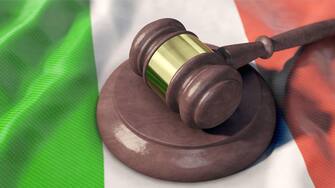 Judge gavel lies on Italy flag