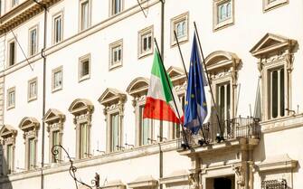 facade of Palazzo Chigi in Rome, seat of the Italian prime minister and government. The Italian and European flags on the balcony of the facade. Outdo