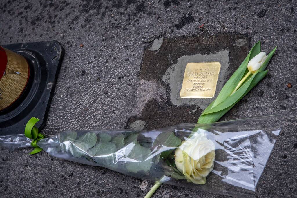 MILAN, ITALY - FEBRUARY 01: Flowers are laid at the Installation of the stumbling stone for Ravenna Giulio In Milan on February 01, 2021 in Milan, Italy. The project started in 1993 by German artist Gunter Demnig, installs tens of thousands of Stolpersteine in front of houses where Jews who were deported to death camps during Germany's Nazi regime, lived. (Photo by Francesco Prandoni/Getty Images)