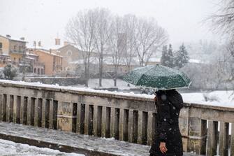 A person walks in the centre of Rieti with an umbrella under the snow, during the snowfall of 23 January 2023.  (Photo by Riccardo Fabi/NurPhoto via Getty Images)