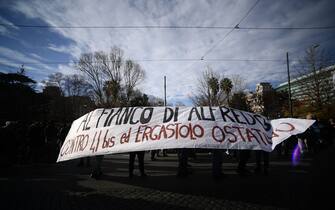 Members of anarchists groups hold a banner reading "alongside Alfredo, against the 41-bis and the life without parole imprisonment" as they stage an unauthorised protest on February 4, 2023 in Rome, in support of anarchist Alfredo Cospito, incarcerated  under the "41-bis" highly restrictive detention regime. - The failing health of an incarcerated anarchist has rekindled debate in Italy over hard prison time usually reserved for mafia bosses, with the new right-wing government vowing not to cave in. Around 730 people behind bars in Italy are subject to the country's highly restrictive detention regime known as "41-bis", among them anarchist Alfredo Cospito, 55. (Photo by Filippo MONTEFORTE / AFP) (Photo by FILIPPO MONTEFORTE/AFP via Getty Images)