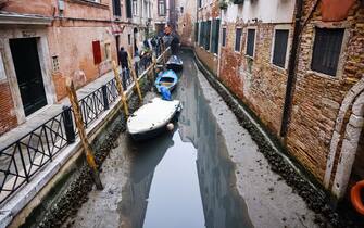 A general view of a dry canal for low tide on February 16, 2023 in Venice, Italy (Photo by Alessandro Bremec/NurPhoto)