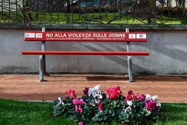 A red bench with the inscription: "No to violence against women" in a street of Bordighera, Imperia, Liguria, Italy