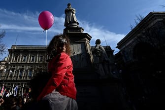 A girl sits on a person's shoulders during a demonstration by gay rights and civil society groups in downtown Milan on March 18, 2023, against moves by Italy's right-wing government to restrict the rights of same-sex parents. (Photo by GABRIEL BOUYS / AFP) (Photo by GABRIEL BOUYS/AFP via Getty Images)