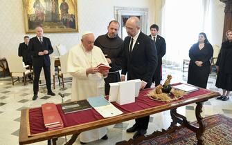 A handout picture provided by the Vatican Media shows Pope Francis (L) exchanging gifts with Ukraine's Prime Minister Denys Shmyhal (R) on the occasion of a meeting, Vatican City, 27 April 2023. ANSA/VATICAN MEDIA HANDOUT HANDOUT EDITORIAL USE ONLY/NO SALES