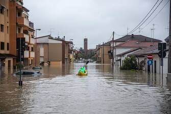 A citizen with an inflatable kayak goes back and forth between the flooded houses to bring some people stuck in the house to dry land, in Cesena, Italy, 17 May 2023. A fresh wave of torrential rain is battering Italy, especially the northeastern region of Emilia-Romagna and other parts of the Adriatic coast. ANSA/MAX CAVALLARI