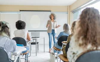 Teacher giving class at college