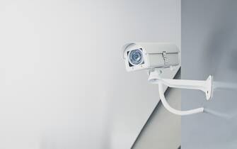 CCTV security camera on wall in the home office for surveillance monitoring home guard system.