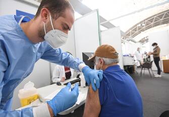 A  health care worker dministers a doses of anti covid vaccine to a Lombard citizens at the vaccination hub in Novegro, near Milan, Italy, 6 May 2021.ANSA/DANIEL DAL ZENNARO