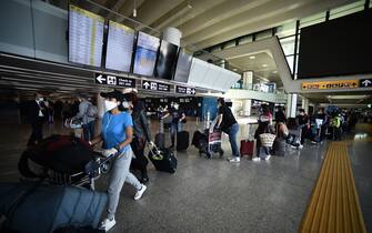 Travelers walk across a terminal at Rome's Fiumicino airport on June 3, 2020, as airports and borders reopen for tourists and residents free to travel across the country, within the COVID-19 infection, caused by the novel coronavirus. (Photo by Filippo MONTEFORTE / AFP) (Photo by FILIPPO MONTEFORTE/AFP via Getty Images)