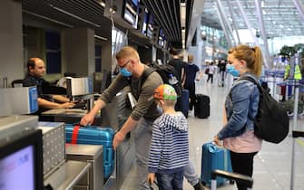DUSSELDORF, GERMANY - JUNE 15: Tourists wait to check in for TUIfly flight X3 2312, the first package tour flight to Mallorca since March, at Dusseldorf Airport during the coronavirus pandemic on June 15, 2020 in Dusselfdorf, Germany. The travellers are participating in a test project in which the Spanish government is allowing up to 11,000 tourists from Germany to travel to the Balearic Islands. Spain, which was hit especially hard by Covid-19, has begun to ease pandemic lockdown measures, though tourist travel is still restricted. The project is meant to test the viability of reopening the country to tourism. (Photo by Andreas Rentz/Getty Images)