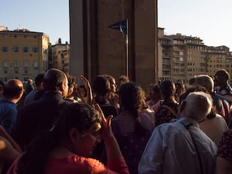 Florence, Italy May 12th 2019. Indian tourists listening their tour guide under the arches of the Uffizi Museum. The Uffizi Museum is one of the most important museum in the world. Inside his room visitors can admire mastepiece of Boticelli, Caravaggio, Michelangelo and Leonardo da Vinci among others.