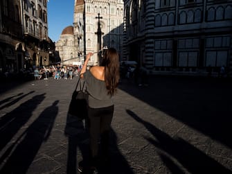 Florence, Italy August 26th 2018. A Tourist taking a selfie in  Piazza del Duomo.