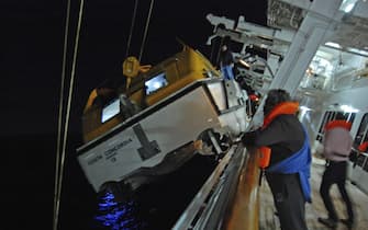 A photo taken by Spanish passenger Carlos Carballa on board cruise boat Costa Concordia and released on 15 January 2012 shows several people preparing a lifeboat after the ship run aground off Italian island Giglio's coast late 13 January 2012. ANSA/CARLOS CARBALLA