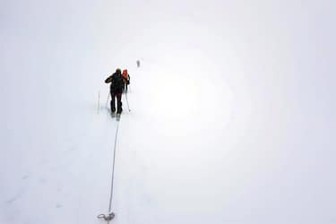 I soccorritori del Soccorso alpino della guardia di finanza durante le operazioni via terra per recuperare due alpinisti bloccati in vetta alla Tour Ronde (3.798 metri) sul versante francese del massiccio del Monte Bianco, 7 marzo 2019.
ANSA/ UFFICIO STAMPA 
++HO -NO SALES EDITORIAL USE ONLY++