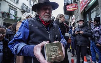 German artist Gunter Demnig at the ceremony where  three 'Snublesten' (Stolpersteine in German) in front of the via Baretti 31 in Turino, il 12 January 2023.  A stumbling block is a memorial stone laid in the pavement next to houses where victims of Nazism had their homes. ANSA/JESSICA PASQUALON