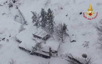 epa05729985 A handout picture provided by the Italian Fire Department shows an aeroal view of hotel Rigopiano after it was hit by an avalanche in Farindola (Pescara), Abruzzo region, early 19 January 2017. According to an Italian mountain rescue team, several people have been killed in an avalanche that has hit a hotel near the Gran Sasso mountain in Abruzzo region. Authorities believe that the avalanche was apparently triggered by a series of earthquakes in central Italy on 18 January.  EPA/ITALIAN FIRE DEPARTMENT HANDOUT BEST QUALITY AVAILABLE HANDOUT EDITORIAL USE ONLY/NO SALES