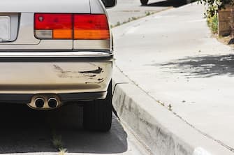 Close up of a rear car bumper side swiped.