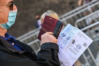 A visitor holds his online-bought entrance ticket as he lines up to enter the Vatican Museums (Musei Vaticani) which reopen to the public on June 1, 2020 in The Vatican, while the city-state eases its lockdown aimed at curbing the spread of the COVID-19 infection, caused by the novel coronavirus. (Photo by ANDREAS SOLARO / AFP) (Photo by ANDREAS SOLARO/AFP via Getty Images)