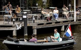 People sit at a cafe's terrace in Amsterdam, on June 1, 2020, as the country eases lockdown mesures taken to curb the spread of the Covid-19 pandemic (novel coronavirus. (Photo by Sem VAN DER WAL / ANP / AFP) / Netherlands OUT (Photo by SEM VAN DER WAL/ANP/AFP via Getty Images)