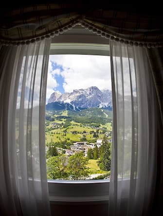 CORTINA D'AMPEZZO, ITALY - JULY 04: Panoramic view from the suite in the 5-Star Hotel Spa and Golf Cristallo, member of The Leading Hotels of the World on July 04, 2011 in Cortina D'Ampezzo, Dolomites, Italy.Cortina is famous for skiing in winter and hiking, climbing, mountainbiking in summer.  (Photo by EyesWideOpen/Getty Images)