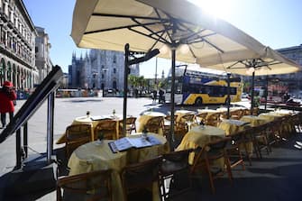 This picture taken on February 27, 2020, shows an empty restaurant in Piazza del Duomo in central Milan. - Italy on Thursday urged tourists spooked by the coronavirus not to stay away, but efforts to reassure the world it was managing the outbreak were overshadowed by confusion over case numbers. (Photo by Miguel MEDINA / AFP) (Photo by MIGUEL MEDINA/AFP via Getty Images)