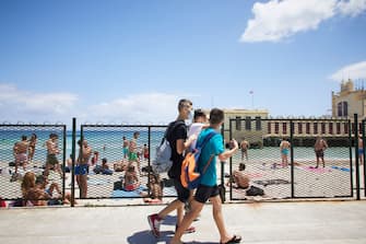 PALERMO, ITALY - JUNE 07:  Some boys walk on Mondello beach on the first day of reopening of the bathing facilities after the lockdown on June 07, 2020 in Palermo, Italy. Many Italian businesses have been allowed to reopen, after more than two months of a nationwide lockdown meant to curb the spread of Covid-19. (Photo by Lorenzo Palizzolo/Getty Images)