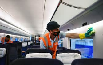 Employees of Germany's public rail operator Deutsche Bahn (DB) clean an inner compartment of an ICE train at a maintenance depot of DB in Dortmund, western Germany, on June 17, 2020 amid the new coronavirus pandemic. (Photo by Ina FASSBENDER / AFP) (Photo by INA FASSBENDER/AFP via Getty Images)