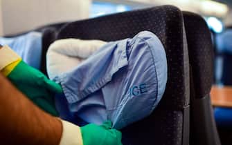 An employee of Germany's public rail operator Deutsche Bahn (DB) changes pillows of the seats in an ICE train at a maintenance depot of DB in Dortmund, western Germany, on June 17, 2020 amid the new coronavirus pandemic. (Photo by Ina FASSBENDER / AFP) (Photo by INA FASSBENDER/AFP via Getty Images)