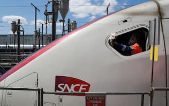 ONET employees desinfect TGV trains locomotive at the SNCF atlantic technicenter, on may 14, 2020, in Chatillon, as the lockdown introduced two month ago to fight the spread of the Covid-19 diseased caused by the novel coronavirus starts to ease. (Photo by Ludovic MARIN / AFP) (Photo by LUDOVIC MARIN/AFP via Getty Images)