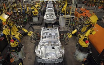 SUNDERLAND, ENGLAND - JANUARY 24:  Robotic arms assemble and weld the body shell of a Nissan car on the production line at Nissan's Sunderland plant on January 24, 2013 in Sunderland, England. The Japanese manufacturer's factory employs 6,225 people producing the Juke, Note and Qashqai models. In 2012 the Wearside facility built 510,572 cars to become the first ever UK automobile plant to have produced more than half a million cars in a year, which was 34.8 percent of the cars produced in the whole of the UK for 2012.  (Photo by Christopher Furlong/Getty Images)