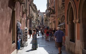 TAORMINA, ITALY:  Tourists in street scene in the city of Taormina, East Sicily, Italy.