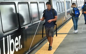 DENVER, COLORADO - AUGUST 30, 2019: A young blind man prepares to board a Denver RTD Light Rail train at Union Station in Denver, Colorado. (Photo by Robert Alexander/Getty Images)