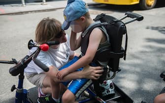 NEW YORK, NY - JULY 12: A mother comforts her son during the first annual Disability Pride Parade on July 12, 2015 in New York City. The parade calls attention to the rights of people with disabilities and coincides with the 25th anniversary of the Americans with Disabilities Act. (Photo by Stephanie Keith/Getty Images)