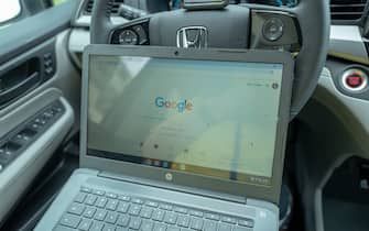 Remote work setup in automobile with Chromebook laptop during COVID-19 coronavirus outbreak in San Francisco, California, March 30, 2020. During the outbreak, many workers have been forced to find creative work at home solutions to respond to lockdowns. (Photo by Smith Collection/Gado/Getty Images)