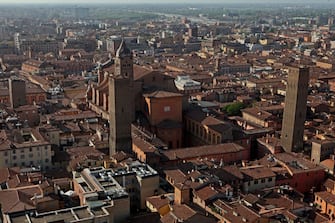 BOLOGNA, ITALY - MARCH 30: The Metropolitan Cathedral of San Pietro, la Cattedrale Metropolitana di San Pietro, is seen with the Torre Azzoguidi (L) in front of its bell-tower on March 30, 2017 in Bologna, Italy. As many as 180 towers are believed to have been built between the 12th and the 13th centuries but only a few remain standing today. (Photo by David Silverman/Getty Images)