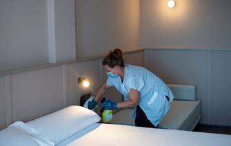 A hotel employee cleans a room in Lloret de Mar on June 22, 2020. - EU member state citizens and those from the passport-free Schengen zone were allowed freely into Spain, with no 14-day quarantines required following a national lockdown to stop the spread of the novel coronavirus. (Photo by Josep LAGO / AFP) (Photo by JOSEP LAGO/AFP via Getty Images)