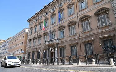 The Italian flag and the flag of Europe fly at half-mast on Palazzo Madama Senate building in Rome on March 31, 2020 as flags are being flown at half-mast in cities across Italy to commemorate the victims of the virus, during the country's lockdown aimed at curbing the spread of the COVID-19 infection, caused by the novel coronavirus. (Photo by ANDREAS SOLARO / AFP) (Photo by ANDREAS SOLARO/AFP via Getty Images)