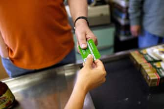 MIAMI - MAY 20:  Yera Dominguez receives a credit card from a customer for payment at Lorenzo's Italian Market on May 20, 2009 in Miami, Florida. Members of Congress today passed a bill placing new restrictions on companies that issues credit. The vote follows the Senate passage of the bill, which now heads for President Obama's promised signature. The bill will curb sudden interest rate increases and hidden fees, requiring card companies to tell customers of rate increases 45 days in advance. It will also make it harder for people aged below 21 to be issued credit cards.  (Photo by Joe Raedle/Getty Images)