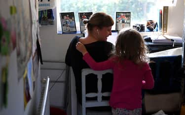 NEWCASTLE UNDER LYME, UNITED KINGDOM - MARCH 25: Four-year-old Lois Copley-Jones, who is the photographer's daughter, disturbs her mother Ruth, who is homeworking on the third day of the nationwide school closures on March 25, 2020 in Newcastle Under Lyme, United Kingdom. British Prime Minister, Boris Johnson, announced strict lockdown measures urging people to stay at home and only leave the house for basic food shopping, exercise once a day and essential travel to and from work. The Coronavirus (COVID-19) pandemic has spread to at least 182 countries, claiming over 10,000 lives and infecting hundreds of thousands more. (Photo by Gareth Copley/Getty Images)