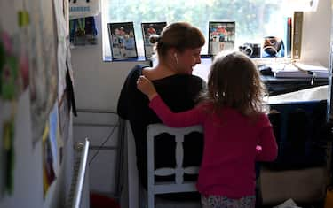 NEWCASTLE UNDER LYME, UNITED KINGDOM - MARCH 25:  Four-year-old Lois Copley-Jones, who is the photographer's daughter, disturbs her mother Ruth, who is homeworking on the third day of the nationwide school closures on March 25, 2020 in Newcastle Under Lyme, United Kingdom. British Prime Minister, Boris Johnson, announced strict lockdown measures urging people to stay at home and only leave the house for basic food shopping, exercise once a day and essential travel to and from work. The Coronavirus (COVID-19) pandemic has spread to at least 182 countries, claiming over 10,000 lives and infecting hundreds of thousands more. (Photo by Gareth Copley/Getty Images)