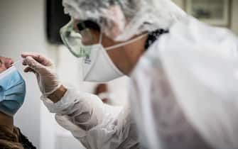 A medical assistant takes a sample from a patient for a coronavirus (Covid-19) test at an analysis laboratory in Le Peage-de-Roussillon, some 30kms south of Lyon, south-eastern France on September 22, 2020. (Photo by JEFF PACHOUD / AFP) (Photo by JEFF PACHOUD/AFP via Getty Images)