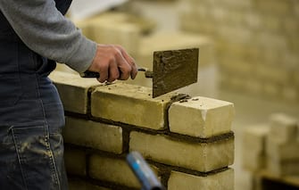 COLOGNE, GERMANY - NOVEMBER 24:  Students with an immigrant background working as a bricklayer at the Vocational training center of the Chamber of Crafts (Bildungszentrum Butzweilerhof der Handwerkskammer) on November 24, 2015 in Cologne, Germany. German industry has complained in recent years of being unable to fill tens of thousands of trainee positions and some see the influx of nearly a million migrants this year as a possible opportunity to narrow the gap.  (Photo by Sascha Schuermann/Getty Images)