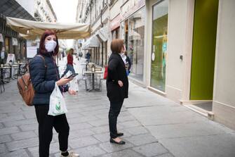 TURIN, ITALY - MAY 29: People wearing a protective mask in a queue outside a clothing store on May 29, 2020 in Turin, Italy. The Piedmont Region in complete autonomy declared that from today 29 May it is mandatory to use the protective mask even outdoors to prevent further infections from Coronavirus (Covid 19). Many Italian businesses have been allowed to reopen, after more than two months of a nationwide lockdown meant to curb the spread of Covid-19. (Photo by Stefano Guidi/Getty Images)