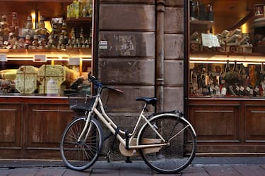 BOLOGNA, ITALY - MARCH 30: A bicycle is parked outside a delicatessen in the historic city center on March 30, 2017 in Bologna, Italy. Cycling is a popular mode of transport in the relatively flat city which sits in the plains of the Po river. (Photo by David Silverman/Getty Images)