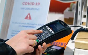PARIS, FRANCE - APRIL 17: A woman types the secret code for her credit card on a bank card reader during the coronavirus (COVID 19) outbreak on April 17, 2020, in Paris, France. The limit of contactless payment will increase from 30 to 50 euros on May 11, the French Banking Federation said on Thursday due to the Coronavirus epidemic. The Coronavirus (COVID-19) pandemic has spread to many countries across the world, claiming over 146,000 lives and infecting over 2.1 million people. (Photo by Chesnot/Getty Images)