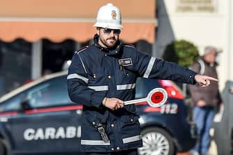 A police officer controls cars and scooters during the limited traffic day, in centeral Rome, on December 29, 2015. 
A second day with limited traffic of odd and even car plate numbers was enforced in the hope of lowering air pollution. A lack of rainfall has led pollution levels to climb in recent weeks, and has prompted the administration of Rome, to appeal to drivers to respect the rules.    / AFP / ANDREAS SOLARO        (Photo credit should read ANDREAS SOLARO/AFP via Getty Images)
