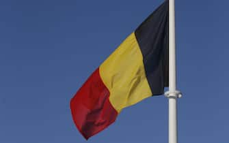 epa05731102 Belgium flag flies near a wind farm outside Perwez, Belgium, 19 January 2017. Due to freezing temperature, high pressure, low winds and problems at some nuclear plants in Belgium and France, Belgium is close to activating their strategic reserves.  EPA/OLIVIER HOSLET