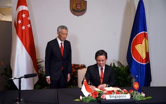 epa08821161 A handout photo made available by Singapore's Ministry of Communications and Information (MCI) shows Prime Minister Lee Hsien Loong (L) and Trade and Industry Minister Chan Chun Sing attending the 4th Regional Comprehensive Economic Partnership (RCEP) Summit and Signing Ceremony via video conference in Singapore, 15 November 2020. Fifteen Asia-Pacific nations signed the Regional Comprehensive Economic Partnership (RCEP) on 15 November, the world's largest free trade deal at the end of an annual summit of Southeast Asian leaders and regional partners.  EPA/MCI HANDOUT  HANDOUT EDITORIAL USE ONLY/NO SALES